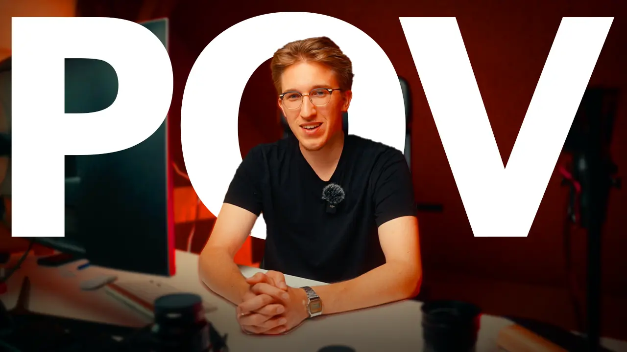 Creator at desk with POV typography overlay and studio lighting